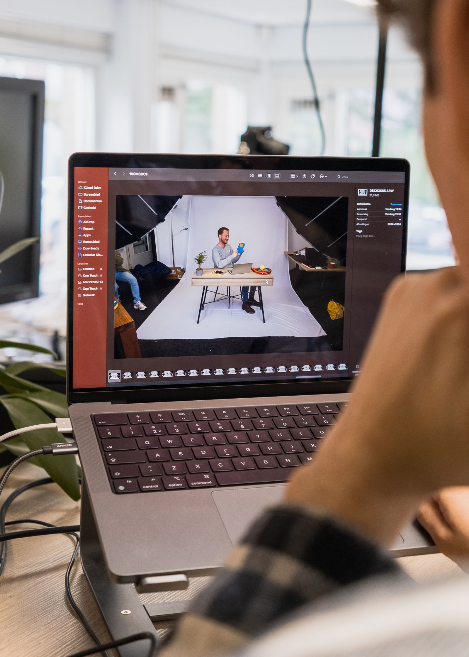 Video editor reviewing production footage on a laptop