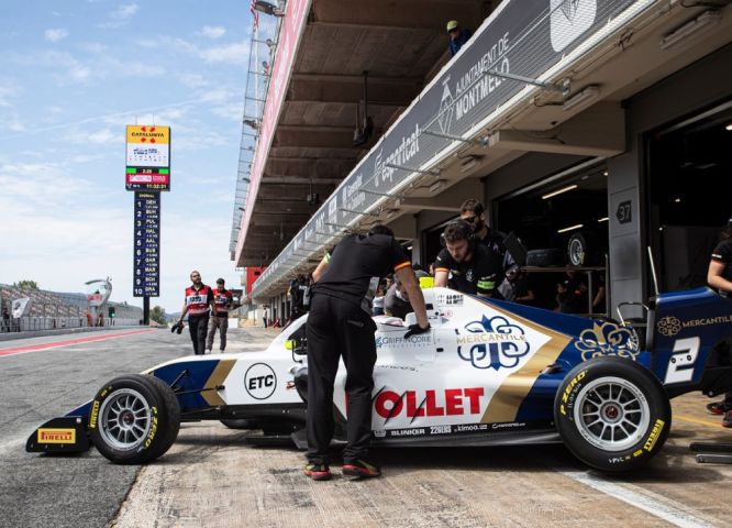 Mercantile F4 race car and crew in the pit lane.
