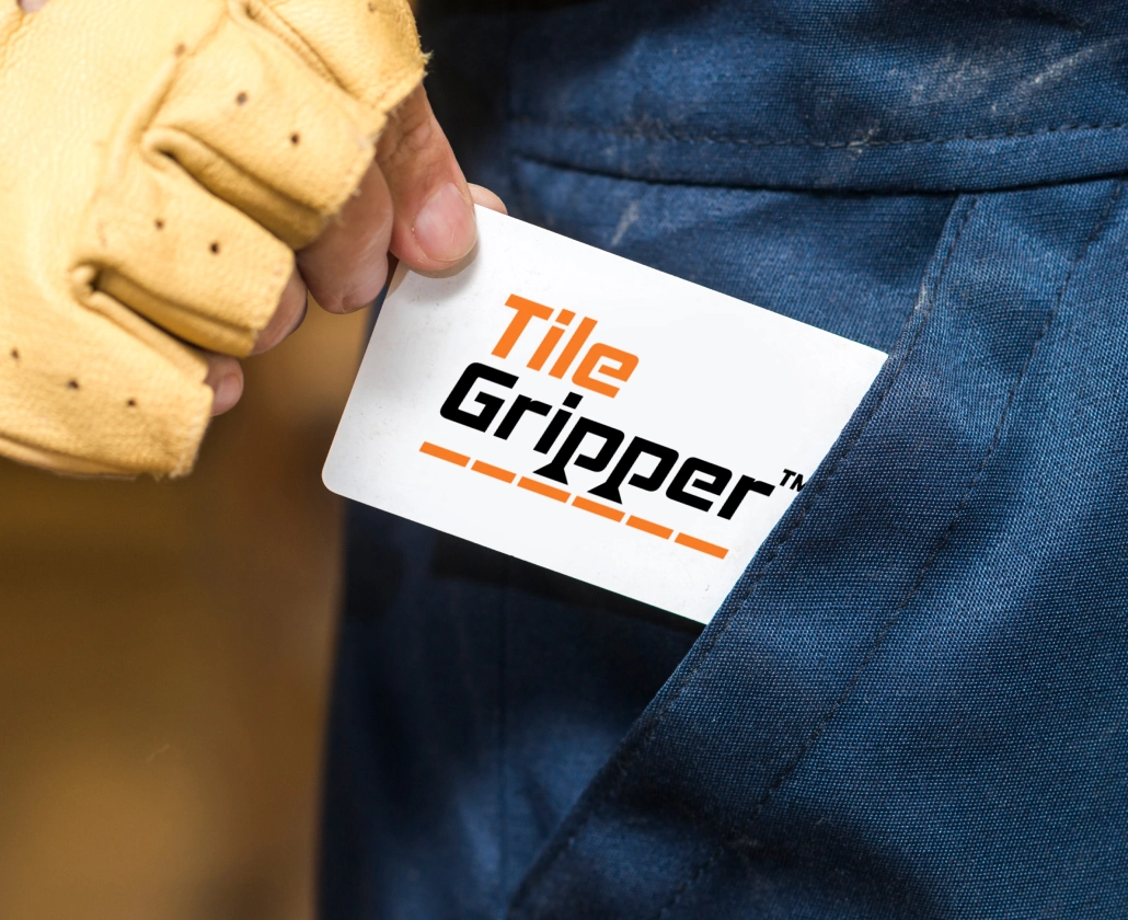 Tile Gripper branded card held by an installer.